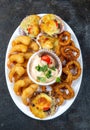 PERUVIAN FOOD. Piqueo caliente. Hot seafood platter fried shrimps, squid rings and baked scallops with sauce Royalty Free Stock Photo