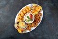 PERUVIAN FOOD. Piqueo caliente. Hot seafood platter fried shrimps, squid rings and baked scallops with sauce Royalty Free Stock Photo