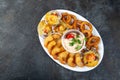 PERUVIAN FOOD. Piqueo caliente. Hot seafood platter fried shrimps, squid rings and baked scallops with sauce Royalty Free Stock Photo