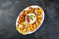 PERUVIAN FOOD. Piqueo caliente. Hot seafood platter fried shrimps, squid rings and baked scallops with sauce Royalty Free Stock Photo