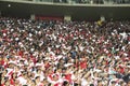 Peruvian football, soccer fans cheering for their team with flag stripes across the face of the stadium. Enthusiastic fans rejoice