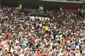 Peruvian football, soccer fans cheering for their team with flag stripes across the face of the stadium. Enthusiastic fans rejoice