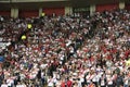 Peruvian football, soccer fans cheering for their team with flag stripes across the face of the stadium. Enthusiastic fans rejoice