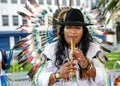 Peruvian Indian in a national costume plays on a pipe 