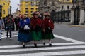 Peruvian indigenous women are crossing the street near the Government palace in Lima, Peru.