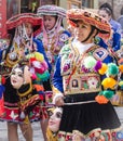 Peruvian ladies dressed in elaborate costumes walking to religious fesitval