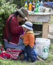 A Peruvian lady and her son at a drink stall next to the Inca ruins of Moray in Peru.