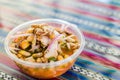 Peruvian mixed ceviche with red onion and fried corn at a street food market Royalty Free Stock Photo