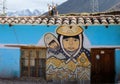 Blue and yellow Peruvian mural of a mother and child