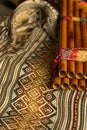 Peruvian pan flute, on a coloured poncho. Concept of traditional Andean music Royalty Free Stock Photo