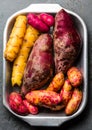 Peruvian raw ingredients for cooking - yuca, colored sweet potatoes and camote batata. Top view Royalty Free Stock Photo