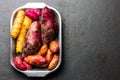 Peruvian raw ingredients for cooking - yuca, colored sweet potatoes and camote batata. Top view Royalty Free Stock Photo