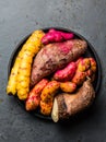Peruvian raw ingredients for cooking - yuca, colored sweet potatoes and camote batata. Top view Royalty Free Stock Photo