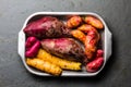 Peruvian raw ingredients for cooking - yuca, colored sweet potatoes and camote batata. Top view Royalty Free Stock Photo