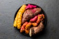 Peruvian raw ingredients for cooking - yuca, colored sweet potatoes and camote batata. Top view Royalty Free Stock Photo