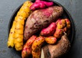 Peruvian raw ingredients for cooking - yuca, colored sweet potatoes and camote batata. Top view Royalty Free Stock Photo