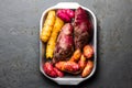 Peruvian raw ingredients for cooking - yuca, colored sweet potatoes and camote batata. Top view Royalty Free Stock Photo