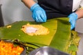 Peruvian recipe for preparing tamales with banana leaves and cornmeal.