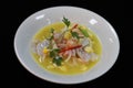 Peruvian seafood ceviche in a bowl with black background