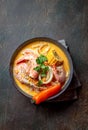 Peruvian seafood soup Chupe de Camarones in gray bowl, top view