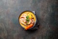 Peruvian seafood soup Chupe de Camarones in gray bowl, top view