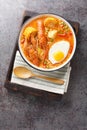 Peruvian soup with crayfish and vegetables close-up on a wooden board. Vertical top view Royalty Free Stock Photo