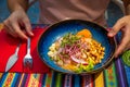 Peruvian-style ceviche plate in outdoor dining, male guest hands ready