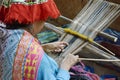 Peruvian woman in traditional clothing weaving cloth on a loom Royalty Free Stock Photo
