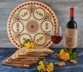 Pesach celebration concept - Jewish holiday Pesach. Background with yellow flowers with glass of wine, matzah and plate Royalty Free Stock Photo