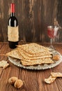 Pesach celebration concept - Jewish holiday Pesach. Matzah on traditional Seder plate with bottle of red wine, glass of Royalty Free Stock Photo