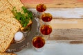 During Pesach, families gather to commemorate liberation of Israelites with red kosher wine a unleavened bread matzo