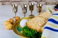 Pesach Passover symbols of great Jewish holiday. Traditional matzo and wine in vintage silver glass