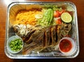 Pescado Frito, a Mexican dish with fried tilapia, yellow rice and salad