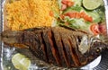 Pescado Frito, a Mexican dish with fried tilapia, yellow rice and salad Royalty Free Stock Photo