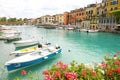 PESCHIERA DEL GARDA, ITALY - JUNE 19, 2020: Peschiera del Garda colorful and flowered harbor with boats moored Lake Garda, Italy Royalty Free Stock Photo