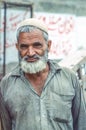 portrait of elderly pakistani man in local clothes with beard
