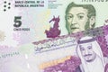 A peso note from Argentina, close up with a Saudi riyal bill