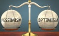 Pessimism and optimism staying in balance - pictured as a metal scale with weights and labels pessimism and optimism to symbolize