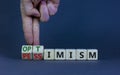 Pessimism or optimism symbol. Businessman turns cubes and changes the word `pessimism` to `optimism`. Beautiful grey table, gr Royalty Free Stock Photo