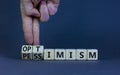 Pessimism or optimism symbol. Businessman turns cubes and changes the word `pessimism` to `optimism`. Beautiful grey table, gr Royalty Free Stock Photo