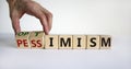 Pessimism or optimism symbol. Male hand turns cubes and changes the word `pessimism` to `optimism`. Beautiful white table, whi Royalty Free Stock Photo