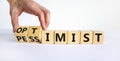 Pessimist or optimist symbol. Businessman turns cubes and changes the word `pessimist` to `optimist`. Beautiful white table, w Royalty Free Stock Photo