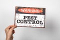 Pest Control. Warning sign with text in woman hand. white background Royalty Free Stock Photo