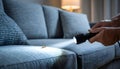 Pest control worker examines a home sofa for cockroaches and other pests using a flashlight. This inspection aims for Royalty Free Stock Photo