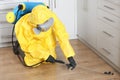 Pest control worker in protective suit spraying pesticide Royalty Free Stock Photo