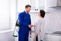 Pest Control Worker Shaking Hands With Woman Royalty Free Stock Photo