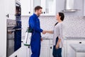 Pest Control Worker Shaking Hands With Woman Royalty Free Stock Photo
