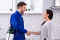 Pest Control Worker Shaking Hands With Woman Royalty Free Stock Photo