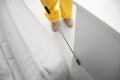 Pest control worker spraying pesticide around furniture, above view Royalty Free Stock Photo