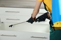 Pest control worker spraying pesticide on furniture, closeup Royalty Free Stock Photo